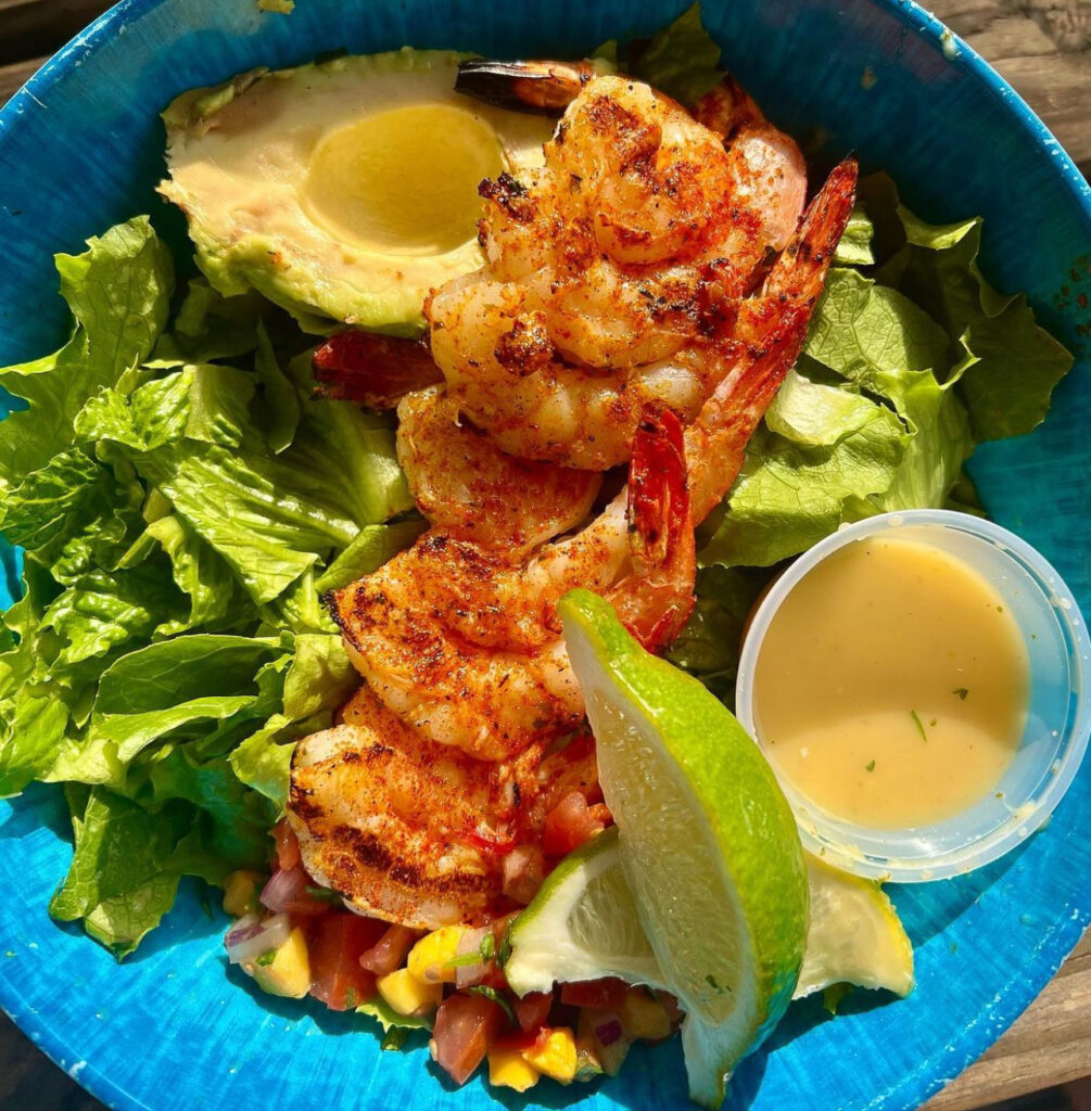 Delicious, colorful shrimp dinner with avocado, lime, and salsa